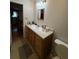 Well-lit bathroom featuring a sink with wooden cabinets and tiled floors at 3398 Highway 81, Oxford, GA 30054