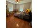 Bright bedroom features hardwood floors and two windows, enhancing the room's natural light at 3398 Highway 81, Oxford, GA 30054