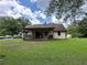 Charming home features a cozy front porch and a spacious green lawn surrounded by mature trees at 3398 Highway 81, Oxford, GA 30054