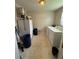 A functional laundry room with a washer, dryer, and tiled floor at 3398 Highway 81, Oxford, GA 30054