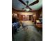 A cozy living room featuring a ceiling fan, wood paneling, and ample seating at 3398 Highway 81, Oxford, GA 30054