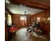 A cozy living room featuring wood paneling, a ceiling fan, and a rocking chair at 3398 Highway 81, Oxford, GA 30054