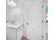 Bright bathroom featuring a white vanity with ample storage and a large mirror with modern lighting at 5325 Trescott Path, Cumming, GA 30028