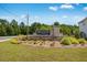 Stone monument sign for Kennison Creek neighborhood under a blue sky with manicured landscaping at 5325 Trescott Path, Cumming, GA 30028