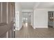 Inviting entryway with wood-look floors, white trim, and a view into the light-filled, open-concept living spaces at 5325 Trescott Path, Cumming, GA 30028