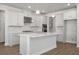 Modern kitchen featuring sleek white cabinetry, stainless steel appliances, and a large center island with a sink at 5325 Trescott Path, Cumming, GA 30028