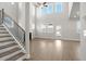 Spacious living room with soaring ceilings, abundant natural light, and a staircase leading to the upper level at 5325 Trescott Path, Cumming, GA 30028