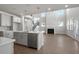 Open-concept living space with high ceilings, large windows, and a seamless flow between kitchen and living room at 5325 Trescott Path, Cumming, GA 30028