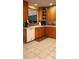 Bright kitchen showcasing wood cabinets, neutral countertops, and tile flooring at 5904 Clairmont Way, Powder Springs, GA 30127