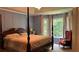 Comfortable main bedroom with a four-poster bed, blue wallpaper, and large windows at 5904 Clairmont Way, Powder Springs, GA 30127