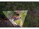 Aerial view showcasing the property within a tree-lined boundary, highlighting its secluded location and well-kept lawn at 9491 Hidden Branch Dr, Jonesboro, GA 30236