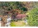 Aerial view of the charming brick home surrounded by mature trees on a large lot at 9491 Hidden Branch Dr, Jonesboro, GA 30236