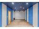 Finished basement with blue walls and carpeting at 9491 Hidden Branch Dr, Jonesboro, GA 30236