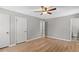 Bedroom featuring wood-look flooring, a ceiling fan, and ensuite bathroom at 9491 Hidden Branch Dr, Jonesboro, GA 30236