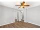 Neutral bedroom features hardwood flooring and a ceiling fan with an light fixture at 9491 Hidden Branch Dr, Jonesboro, GA 30236