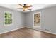 Bedroom with two large windows, updated floors and a ceiling fan at 9491 Hidden Branch Dr, Jonesboro, GA 30236