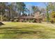 Charming brick home featuring a well-manicured lawn and beautiful landscaping at 9491 Hidden Branch Dr, Jonesboro, GA 30236