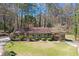 Charming brick home featuring a well-manicured lawn and beautiful landscaping at 9491 Hidden Branch Dr, Jonesboro, GA 30236