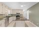 Bright kitchen features granite countertops, stainless steel appliances, and a central island with tiled backsplash at 9491 Hidden Branch Dr, Jonesboro, GA 30236