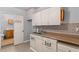 Compact kitchen with double sink, tile backsplash, and cabinetry at 9491 Hidden Branch Dr, Jonesboro, GA 30236