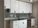 Modern kitchen featuring updated stainless steel appliances and granite countertops at 9491 Hidden Branch Dr, Jonesboro, GA 30236