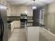 Updated kitchen featuring granite countertops, stainless steel appliances, and a large center island at 9491 Hidden Branch Dr, Jonesboro, GA 30236