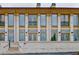 Beautiful brick building showcasing large windows, a small balcony, and exterior lighting at 140 Rolison Way, Fayetteville, GA 30214
