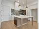 Kitchen with an island, white cabinets, stainless steel appliances, and unique tile backsplash at 140 Rolison Way, Fayetteville, GA 30214
