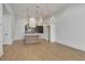 Modern kitchen featuring an island, stainless steel appliances, and stylish hanging lights at 140 Rolison Way, Fayetteville, GA 30214