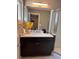 Modern bathroom featuring a dark wood vanity, white countertop, and glass enclosed shower at 1400 Peter Haughton Nw Way, Atlanta, GA 30318