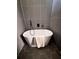 Modern bathroom highlighting a freestanding tub with hexagon tile floors at 1400 Peter Haughton Nw Way, Atlanta, GA 30318