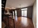 Open-concept living space with hardwood floors, a modern chandelier, and access to a balcony at 1400 Peter Haughton Nw Way, Atlanta, GA 30318