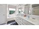 Large bathroom with dual sinks, a soaking tub, and a separate shower with a large window at 1811 Ascot Nw Cv, Acworth, GA 30102