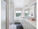 Bright bathroom with double vanity, large soaking tub, and a separate glass-enclosed shower at 1811 Ascot Nw Cv, Acworth, GA 30102