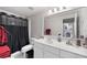 This bathroom features a vanity and a shower with a black shower curtain at 1811 Ascot Nw Cv, Acworth, GA 30102