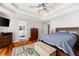 Bedroom with hardwood floors, tray ceiling, and ensuite access to the Primary bathroom at 1811 Ascot Nw Cv, Acworth, GA 30102