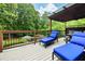 Relaxing deck features comfortable lounge chairs with blue cushions, ideal for enjoying outdoor living and poolside views at 1811 Ascot Nw Cv, Acworth, GA 30102