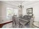 Bright dining room with modern chandelier, trim accents, and large windows for ample natural light at 1811 Ascot Nw Cv, Acworth, GA 30102