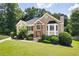 Stunning two-story home featuring a lush lawn and mature trees in a serene, wooded setting at 1811 Ascot Nw Cv, Acworth, GA 30102