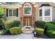 Elegant front entrance with stone accents, double doors, and professionally landscaped surroundings at 1811 Ascot Nw Cv, Acworth, GA 30102