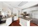 Well-lit kitchen boasts stainless appliances, white cabinets, granite counters, and a central island at 1811 Ascot Nw Cv, Acworth, GA 30102