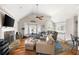 Open living room featuring vaulted ceilings, a fireplace, hardwood floors, and large windows at 1811 Ascot Nw Cv, Acworth, GA 30102