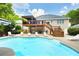 A pristine inground pool is surrounded by lounge chairs, offering a luxurious outdoor experience in this home's backyard at 1811 Ascot Nw Cv, Acworth, GA 30102