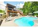Lovely pool with an upper deck and an expansive patio provides a serene and private backyard retreat at 1811 Ascot Nw Cv, Acworth, GA 30102