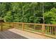 Wooden back deck overlooking lush green trees at 3159 Stonegate Sw Dr, Atlanta, GA 30331