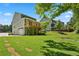 Spacious backyard with lush green lawn and a two-story house, ideal for outdoor activities at 3159 Stonegate Sw Dr, Atlanta, GA 30331