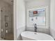 Modern bathroom featuring standalone tub and frameless shower at 3159 Stonegate Sw Dr, Atlanta, GA 30331