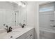 Modern bathroom features double vanity with granite countertop and large mirror, next to toilet and walk-in shower at 3159 Stonegate Sw Dr, Atlanta, GA 30331