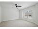 Bright bedroom featuring neutral carpet, ceiling fan, and large window at 3159 Stonegate Sw Dr, Atlanta, GA 30331