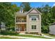 Charming two-story home with a brick and siding exterior, a small yard, and a cozy, inviting front porch and balcony at 3159 Stonegate Sw Dr, Atlanta, GA 30331